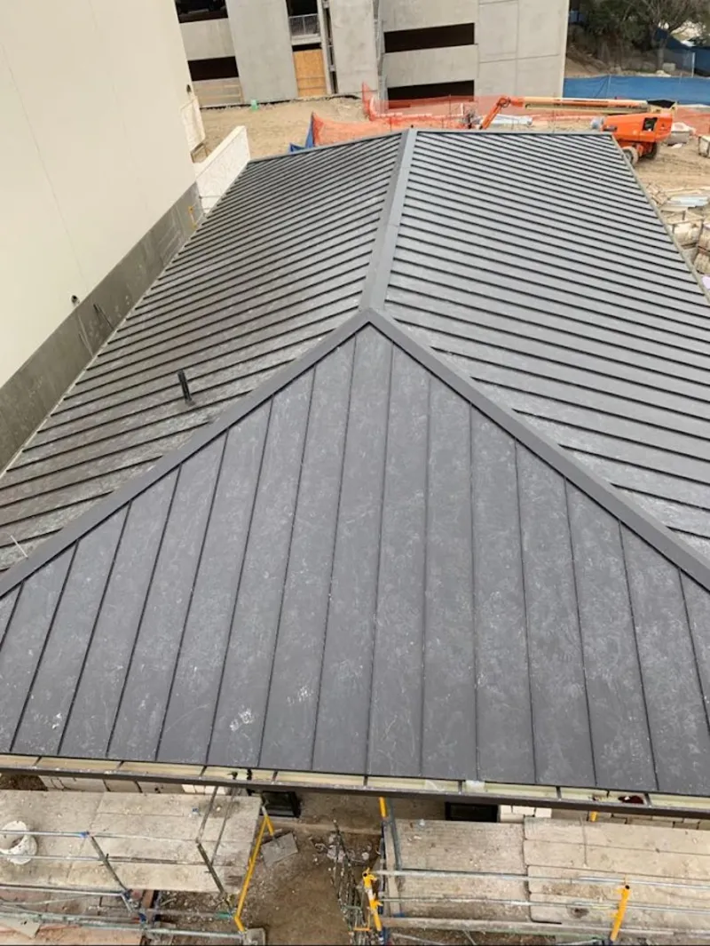 Commercial metal roof construction with crane equipment in Wilkinsburg